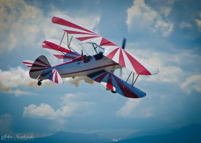 Gary Rower Waiving to Crowd in a Flyby in His Stearman