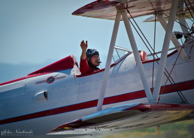 Gary Rower Waiving to Crowd in His Stearman