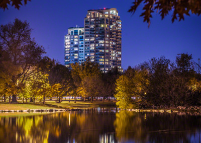 Denver Condo Building Reflecting on City Park Lake at Night