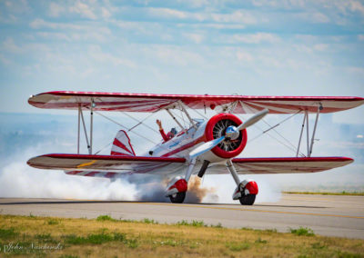 Boeing Stearman Biplane Taxing Runway Streaming Smoke for the Crowd