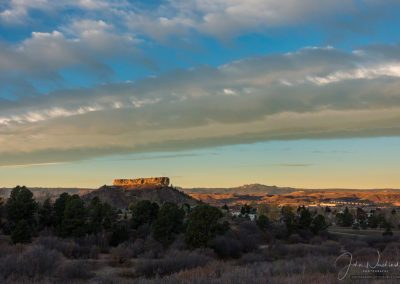 Beautiful Blue Skies and Warm Colored Clouds First Light on the Rock in Castle Rock CO