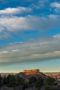 Vertical Photo of Beautiful Blue Skies and Warm Colored Clouds First Light on the Rock in Castle Rock CO
