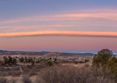 Wide Panoramic Photo of Orange Pink Bow Cloud Over Castle Rock at Sunrise