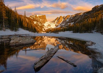 Photo of Partially Frozen Dream Lake Reflecting Hallett Peak with Bow Clouds