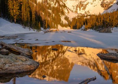 Vertical Photo of Partially Frozen Dream Lake Reflecting Hallett Peak with Dramatic Bow Clouds