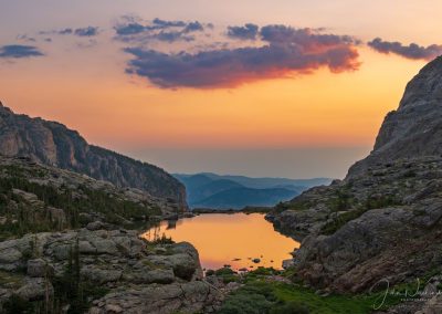 Spectacular Colors of Sunrise Illuminating Clouds and Reflecting Upon Lake of Glass RMNP