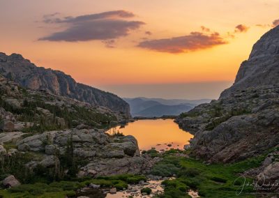 Warm Amber Sunrise Reflecting Upon Lake of Glass Below Sky Pond