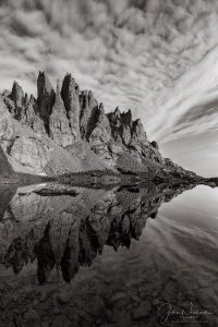 Vertical Black and White Photo of Mirror Reflection of Cathedral Spires and Sky Pond RMNP Colorado