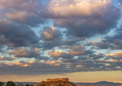 Vertical Photo of Colorful Cotton Ball Shaped Clouds over Castle Rock at Sunrise