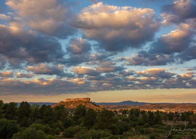 Photo of Colorful Cotton Ball Shaped Clouds over Castle Rock at Sunrise