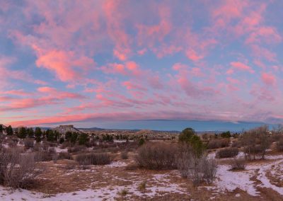 Panoramic Photo of Dramatic Pink Clouds over the Castle Rock Star after Light Autumn Snow