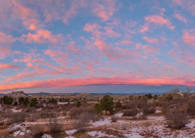 Panoramic Photo of Colorful Pink Clouds over Castle Rock just before Sunrise