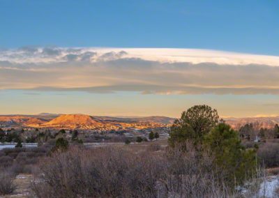 Panoramic Photo of Bow Cloud over Castle Rock at First Light after Light Evening Snow