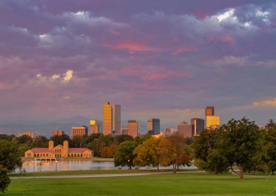 Pastel Colors of Sunrise Illuminate the Sky Above City Park in this Photo of Denver City Skyline