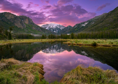 Purple Orange and Pink Sunrise over Snow Capped Mt Baldy Reflecting upon still waters of the East Inlet RMNP Colorado