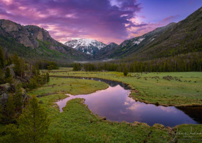 Beautiful Sunrise over Snow Capped Mt Baldy with blue sky and sunrise colors reflecting upon waters of the East Inlet RMNP Colorado