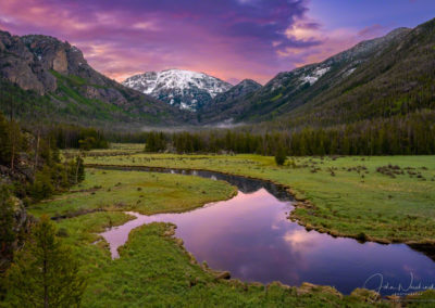 Colorful Sunrise over Snow Capped Mt Baldy with sunrise colors reflecting upon waters of the East Inlet RMNP Colorado