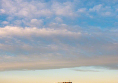 Clouds and Blue Sky Colorful Sunrise Vertical Photo of First Light on Castle Rock Colorado - Winter 2019
