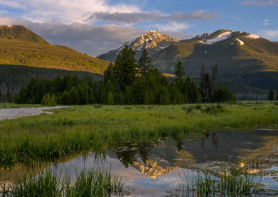 Dappled Light on Baker Mountain as it Reflects on a Pond at Rocky Mountain National Park