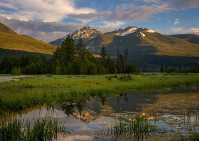 Dramatic Dappled Light on Baker Mountain as it Reflects on a Pond at Rocky Mountain National Park
