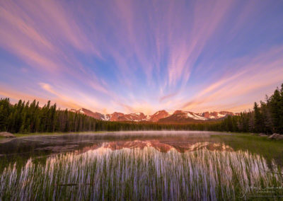 Low lying fog and wispy wind blown clouds over Biersradt Lake at Sunrise