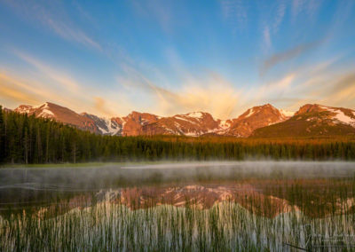 Photo of low lying fog and high wind blown clouds over Biersradt Lake RMNP at Sunrise