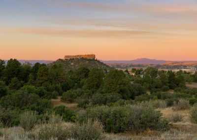 Pastel Sunrise Clouds with First Light on the Rock - Castle Rock CO