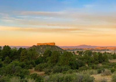 Yellow Orange Clouds with First Light on the Rock - Castle Rock CO