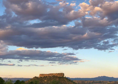 Photo of The Rock with Dramatic White Clouds Above