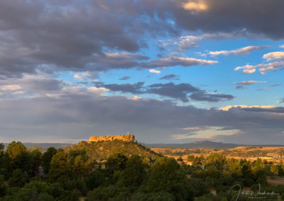 First Light and Dramatic Clouds over the Rock - Castle Rock CO