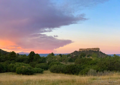 Photo of Purple Pink Glowing Clouds and Blue Skies at Sunrise over Castle Rock
