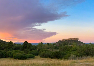 Photo of Purple Pink and Orange Glowing Clouds with Blue Skies at Sunrise over Castle Rock
