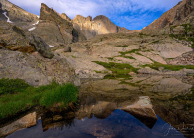 Photo of Dramatic Light on Longs Peak Reflecting in Seasonal Alpine Pond Below Chasm Lake RMNP Colorado