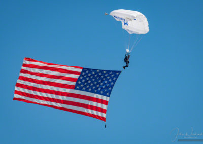 US Air Force Wings of Blue Parachute Demonstration Team Member Proudly Displaying US Flag During National Anthem