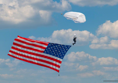 US Air Force Wings of Blue Parachute Demonstration Team Member Displaying US Flag During National Anthem