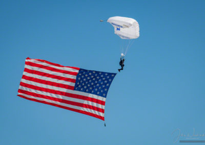 US Air Force Wings of Blue Parachute Team Member Flying US Flag During National Anthem