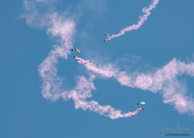 US Air Force Wings of Blue Parachute Team Members Performing Aerial Maneuvers with Smoke Trails