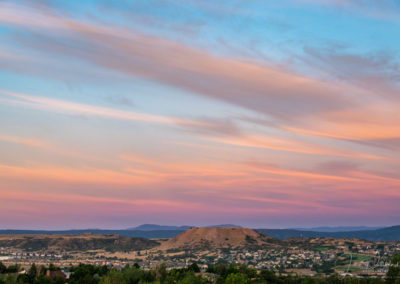 Blue Skies and Colorful Wispy Clouds over Castle Rock Colorado at Sunrise