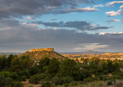 First Light on the Rock with White Clouds over Castle Rock Colorado at Sunrise