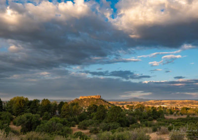 High Dramatic White Billowy Clouds over The Illuminated Rock