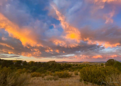 Dramatic and Colorful Clouds appear above Castle Rock on an Autumn Sunrise