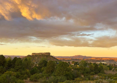 Warm Light Illuminates Clouds at Sunrise in this Photo of Castle Rock Colorado