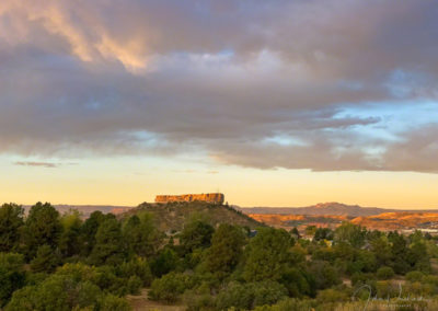 First Light Illuminates the top of The Rock at Sunrise in this Photo of Castle Rock Colorado