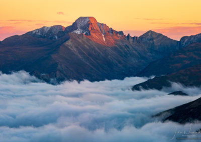 Orange Pink Sunset Photo of Longs Peak with Layers of Fog in Valley Below