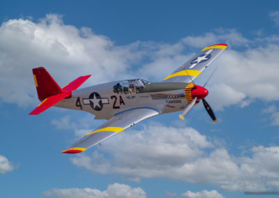 Photo of The CAF Red Tail Squadron’s P-51C Mustang, Tuskegee Airmen in Flight at Colorado Springs Airshow