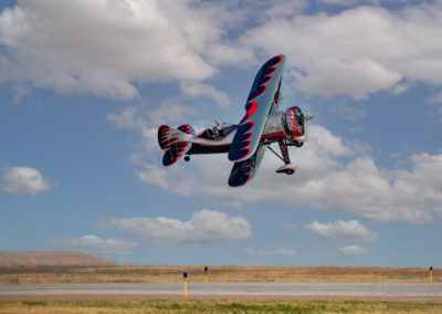 Kyle Franklin in Dracula Biplane flying close to ground at Pikes Peak Regional Airshow