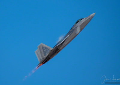 Vapors and After Burners on F-22 Raptor Stealth Fighter in Vertical Climb