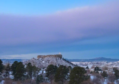 Vertical Photo of Pre-Dawn Light with Blue Skies and Purple Bow Cloud over Castle Rock CO