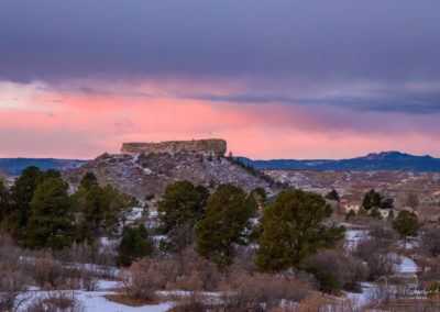 Dramatic Pink Magenta Clouds behind Illuminated Castle Rock Star