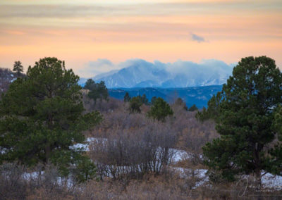 Colorful Skies and Clouds Cling to Pikes Peak in this Sunrise Photo